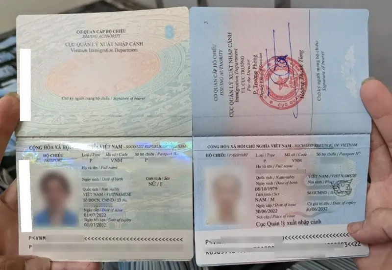 Hộ chiếu Việt Nam mẫu mới bìa màu xanh tím than (bên trái) và mẫu cũ bìa xanh lá (bên phải) có sự khác nhau về cách bố trí khung chữ ký người mang hộ chiếu